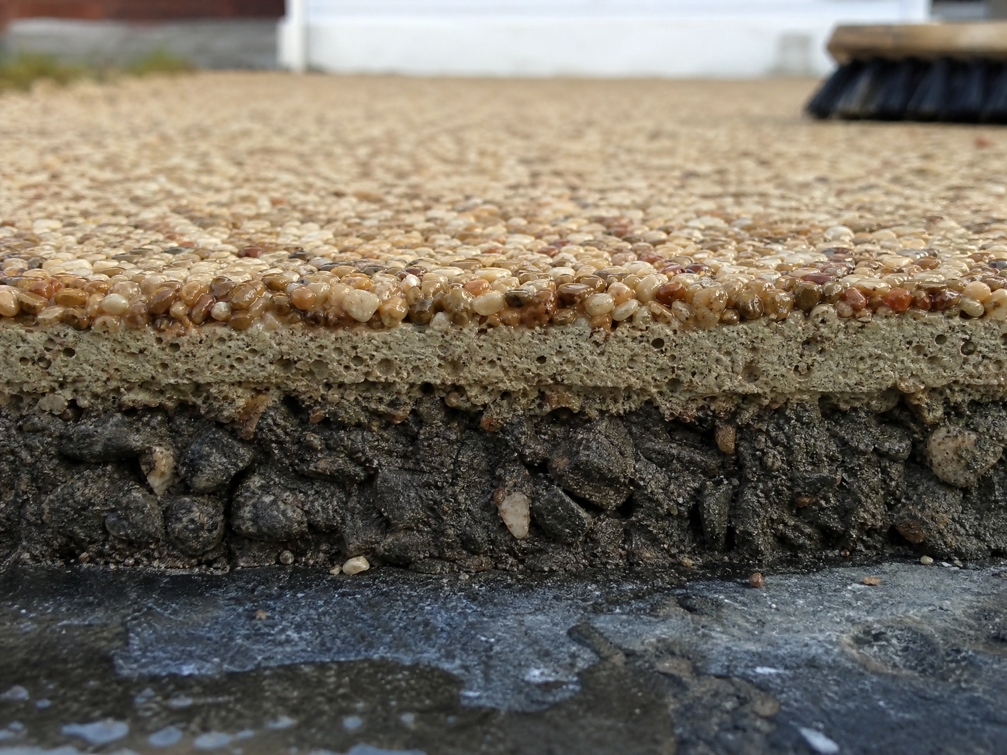 Close-up detail of materials and technique used in resin driveway repairs & cleaning — showing quality
